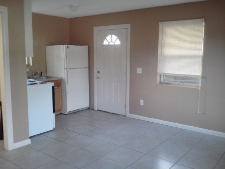 2nd unit open area - kitchen, dining room and living room the door you are seeing is the back door to the 2nd unit.  there is a front door behind the photographer.